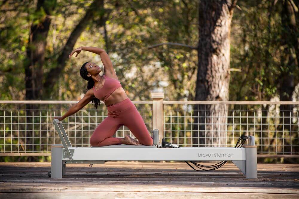 Pilates exercise on Bravo Reformer in an outdoor setting.