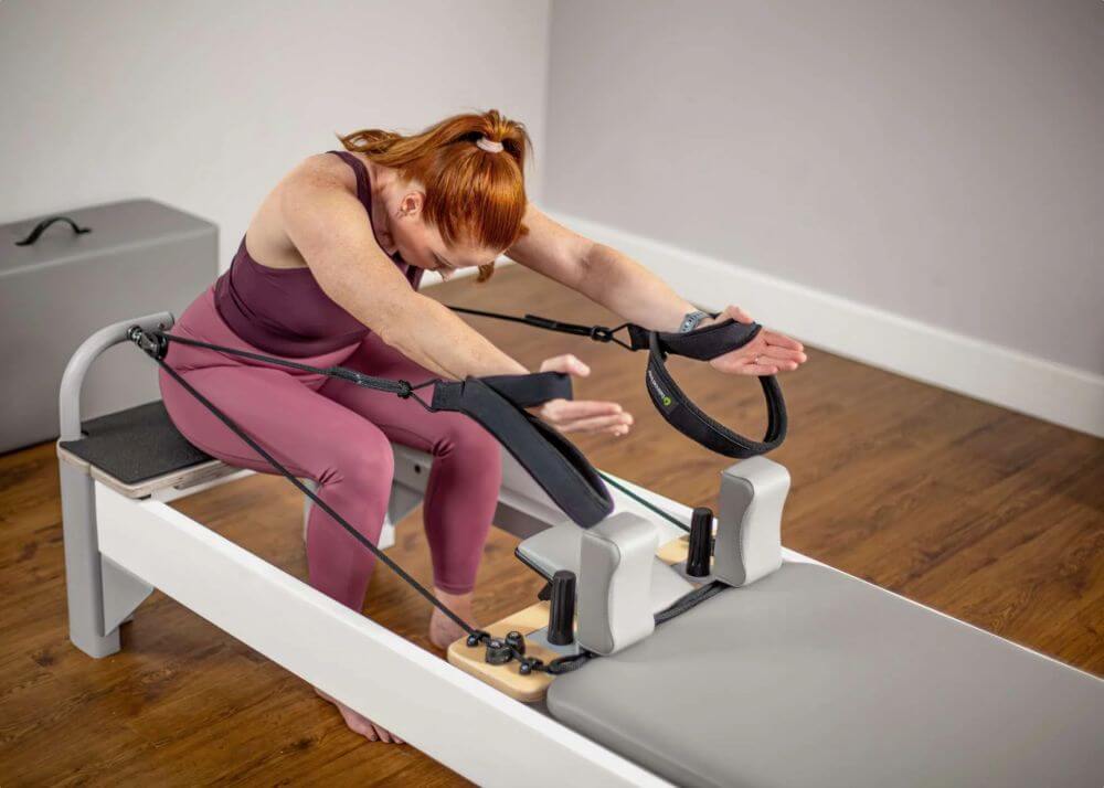 Woman using Bravo Reformer with Extended Head End Platform