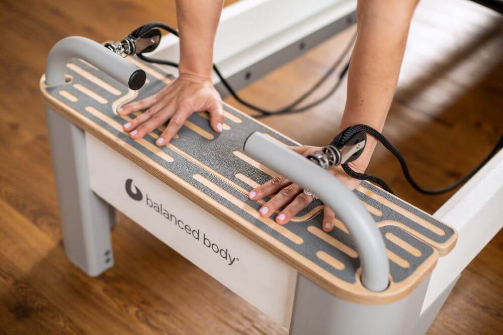 Bravo Reformer Platform Extender with hands on non-slip surface.