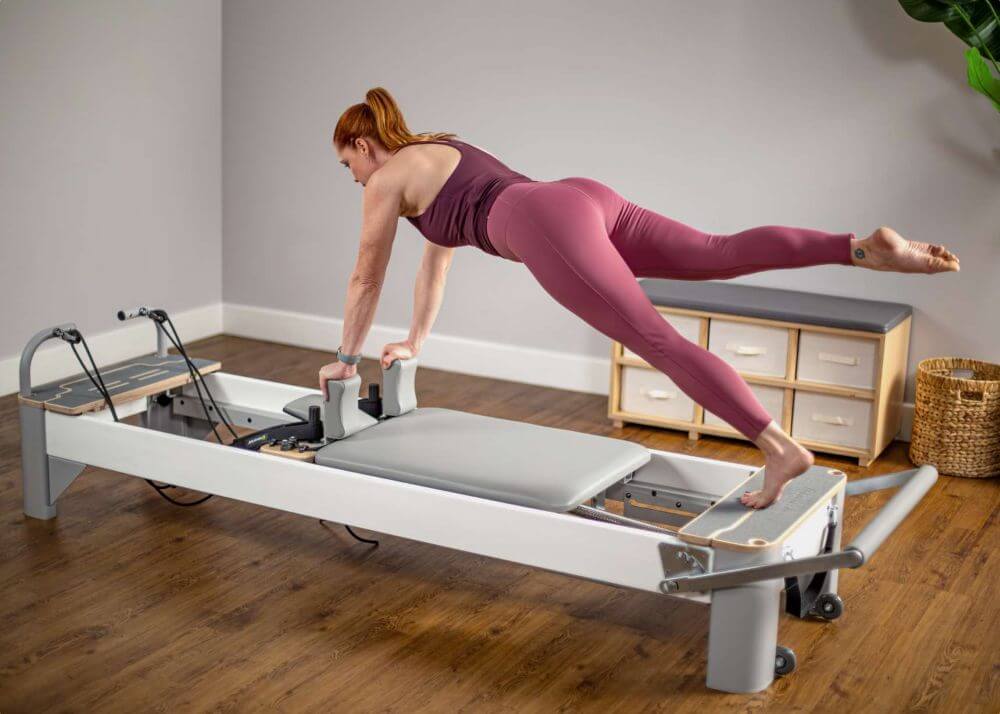 Person exercising on Bravo Reformer with Platform Extender.