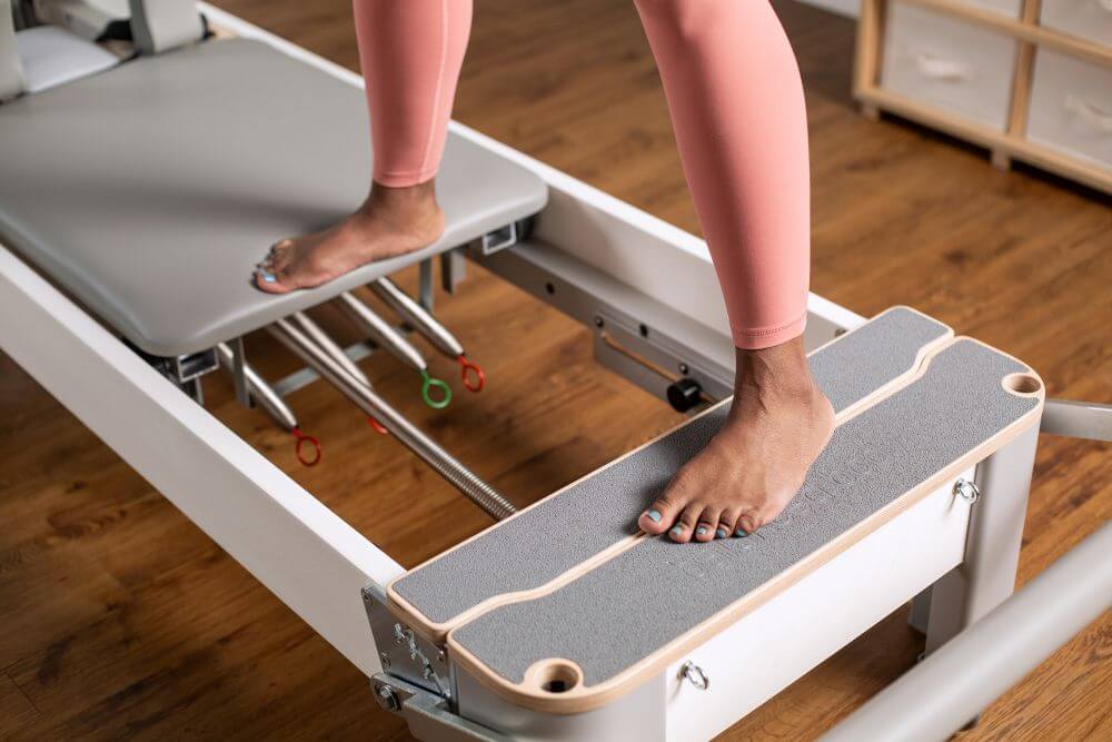 Bravo Reformer Platform Extender with feet demonstrating use.